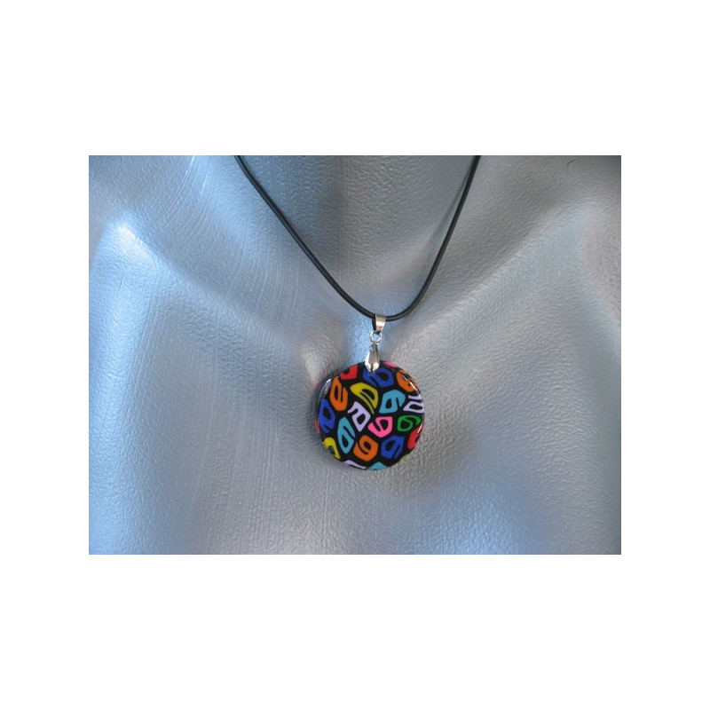 Small pop pendant, multicolored patterns, on a black Fimo background