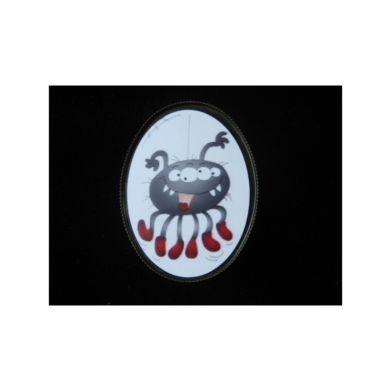 Oval brooch, cartoon spider, set in resin