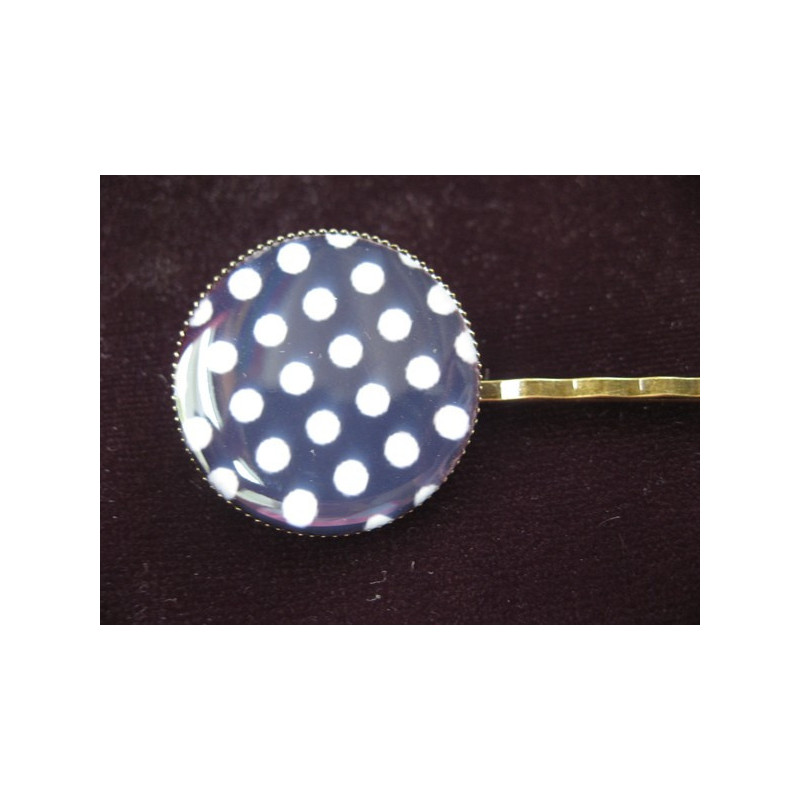 Fancy hair clip, white dots, on a black background