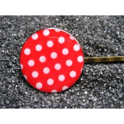 Fancy hair clip, white dots, on a red background