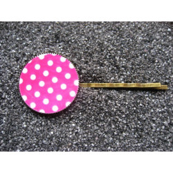 Fancy hair clip, white dots, on a fuchsia background