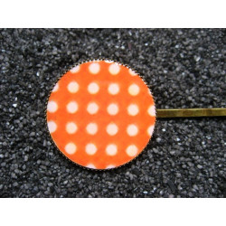 Fancy hair clip, white dots, on an orange background