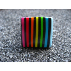 Small pop ring, multicolored stripes, on a black background, in Fimo