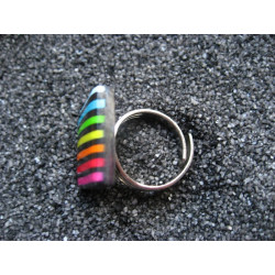 Small pop ring, multicolored stripes, on a black background, in Fimo