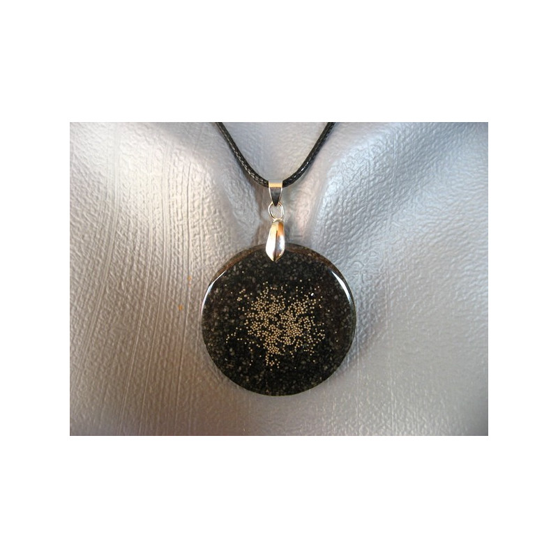 Fancy pendant, silver microbeads, on a black resin background