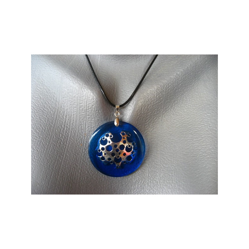 Graphic pendant, silver print, on blue resin background