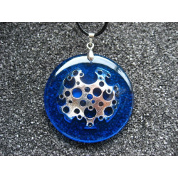 Graphic pendant, silver print, on blue resin background
