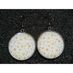 Earrings, golden polka dots on a white background, set in resin