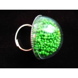 Dome ring, mobile green minipearls, in a plexiglass hemisphere