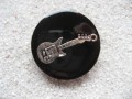 Large fancy ring, silver guitar, on a black resin background