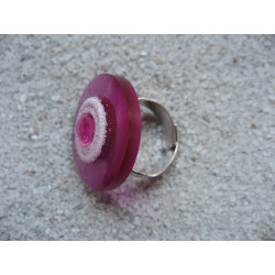 Fancy ring, fuchsia pearl, on white background and fuchsia in resin