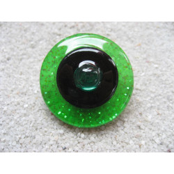 Large graphic ring, green pearl, on black and green resin background
