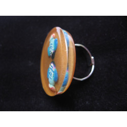 Large summer ring, fishes in love, on a background of sand in resin
