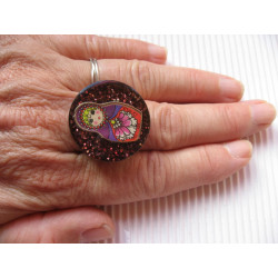 Fancy ring, Russian doll, on plum resin background