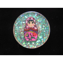 Large fancy ring, Russian doll, on a pearly white resin background