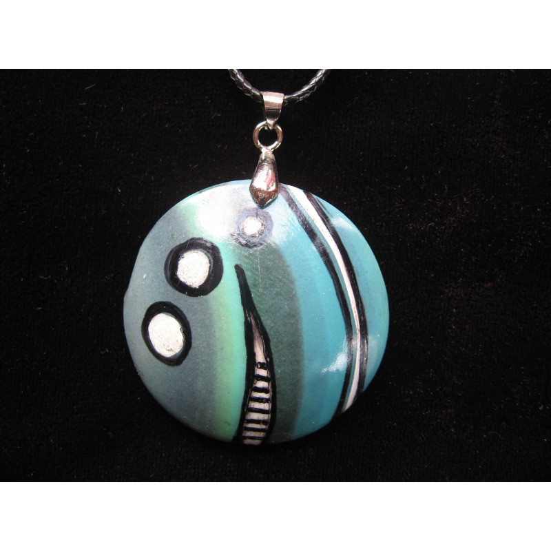 Graphic pendant, black and white patterns, on a turquoise Fimo background