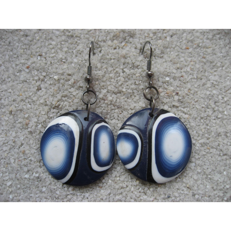 Graphic earrings, white and black patterns on a blue background, in fimo