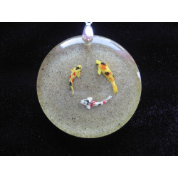 Summer pendant, round of fish, on sand background, in resin