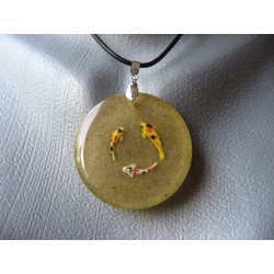 Summer pendant, round of fish, on sand background, in resin