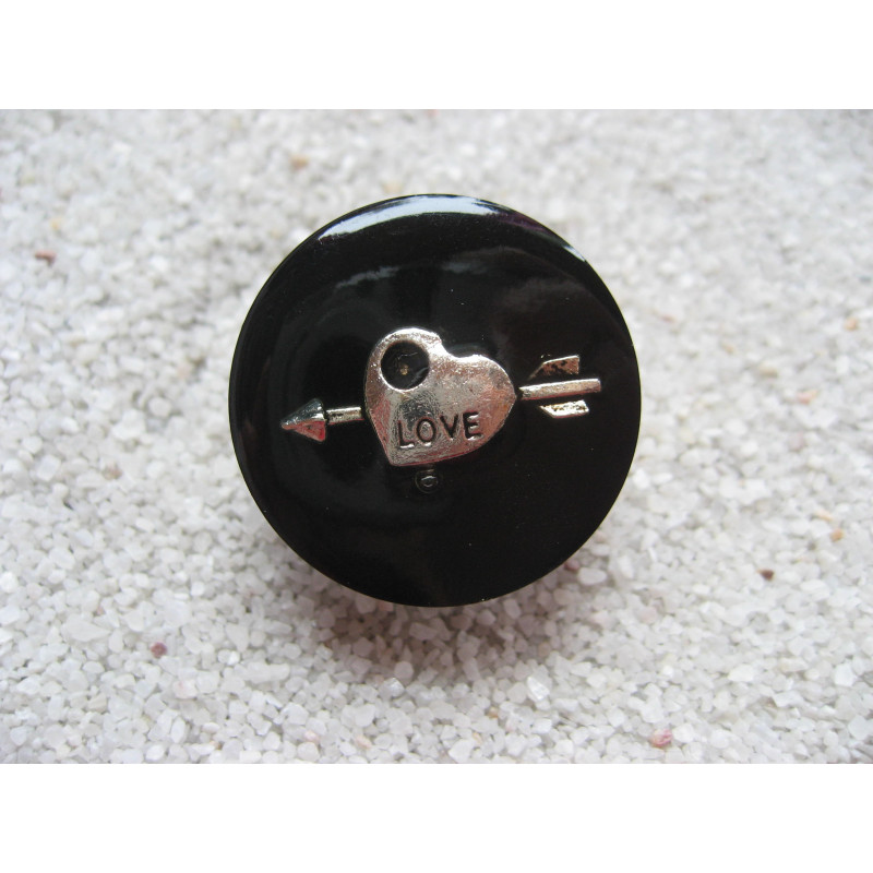 Fancy ring, silver arrow heart, on black resin background