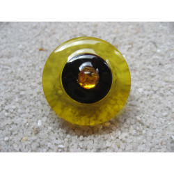 Fancy ring, yellow pearl, on black and yellow background in resin