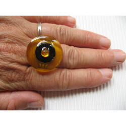 Fancy ring, yellow pearl, on black and yellow background in resin