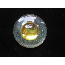 Big graphic ring, yellow pearl, on a white resin background