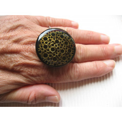 Large ring, perforated bronze print, black resin background