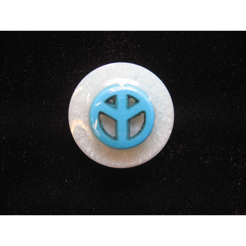 Fancy ring, peace and love turquoise cabochon, on a white resin background