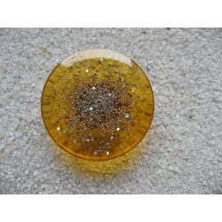 Large ring, silver microbeads, on a orange resin background