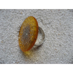 Large ring, silver microbeads, on a orange resin background