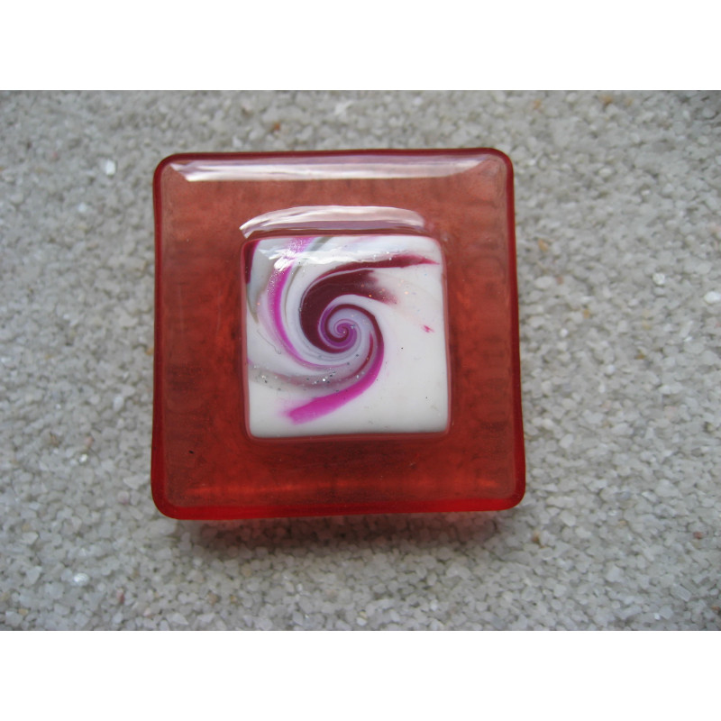Very large square ring, white fuchsia spiral cabochon, on a red resin background