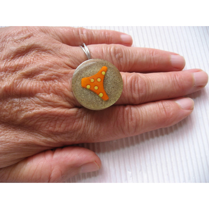 Summer ring, orange bikini bottom, on resin sand background