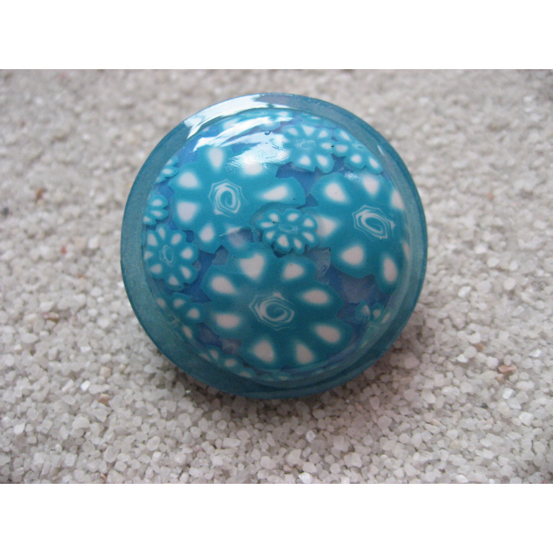 Large ring, turquoise floral cabochon, on pearly blue resin background