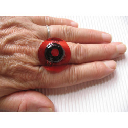 Fancy ring, red pearl, on black and red background in resin
