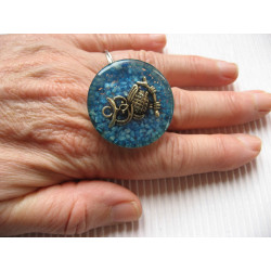 Large fantasy ring, silver owl, on a turquoise resin background