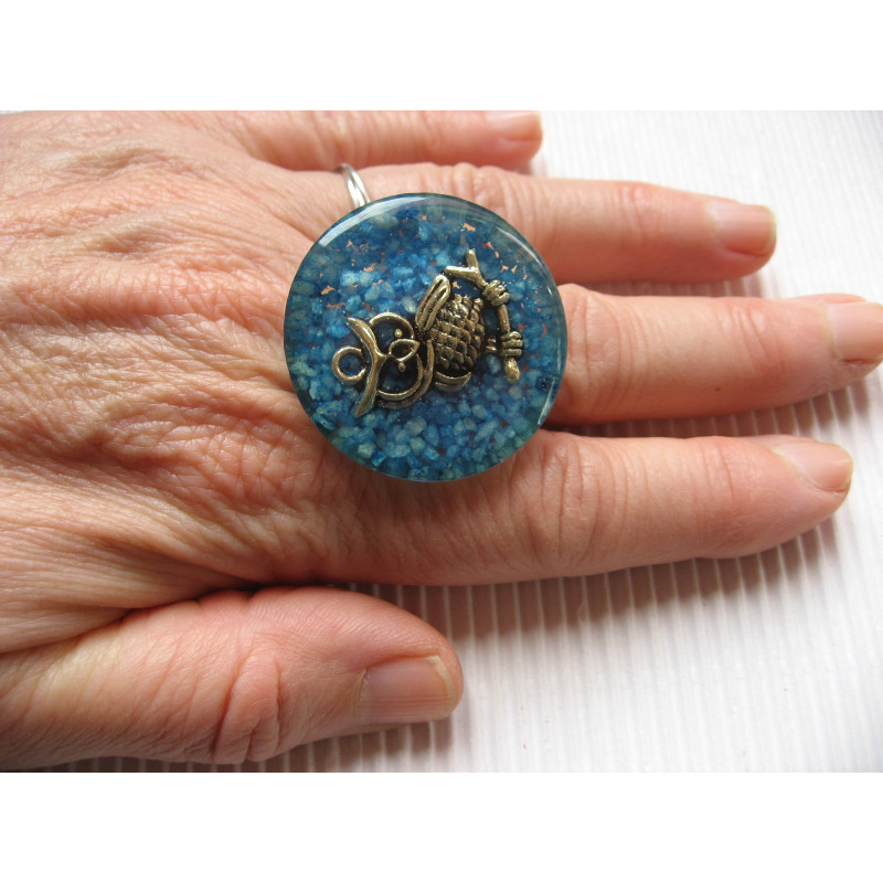 Large fantasy ring, silver owl, on a turquoise resin background