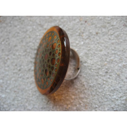 Very large ring, bronze print, orange resin background