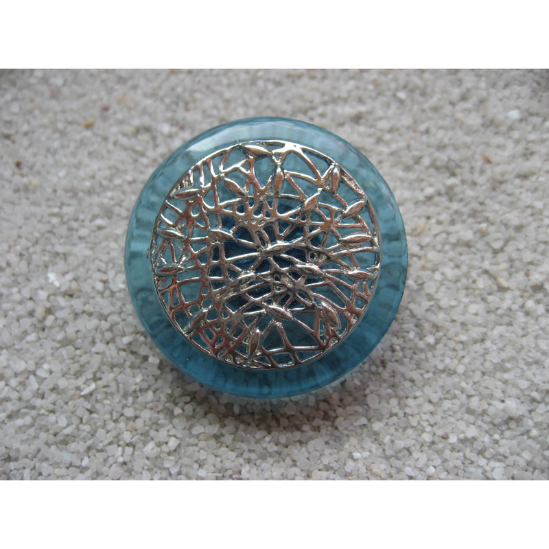 Large ring, silver print, on blue resin background