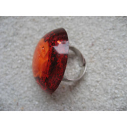 Large cabochon ring, orange flower, on an orange glittery resin background