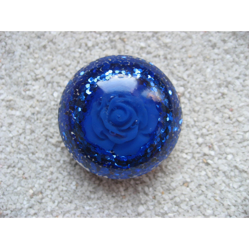 Large cabochon ring, blue flower, on a glittery blue resin background