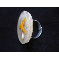 Large summer ring, orange starfish, on resin sand background