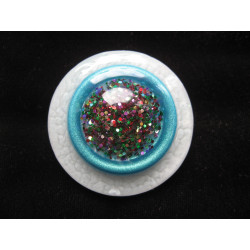 Very large ring, multicolored glitter cabochon, on an turquoise and white pearlescent resin background