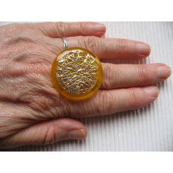 Large graphic ring, Silver print, on a yellow resin background