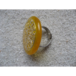 Large graphic ring, Silver print, on a yellow resin background