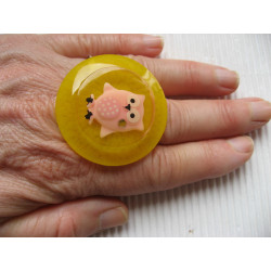 Very large pink owl ring in fimo on a yellow resin background